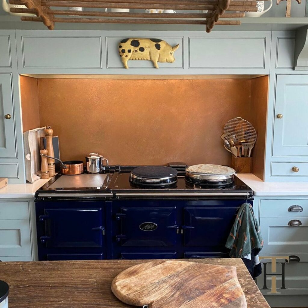 copper splashback behind aga in kitchen