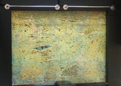 decorative brass splashback with blues greens and pinks
