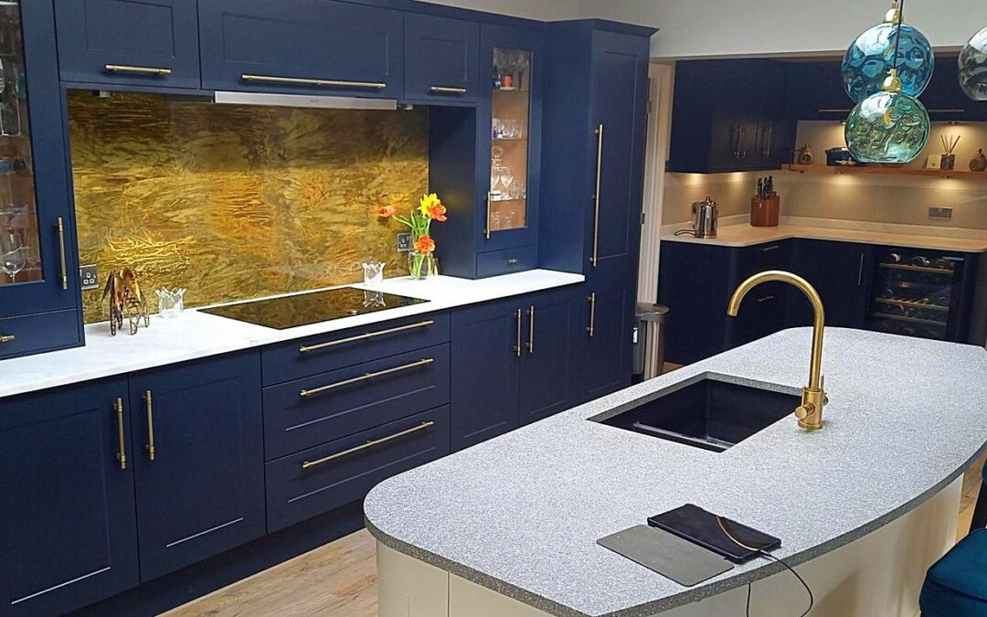 aged brass splashback in blue kitchen