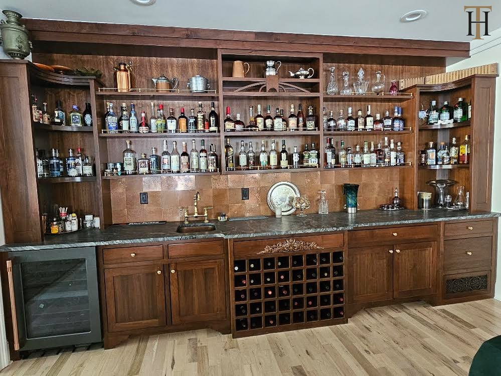 Aged copper tiles used as an alternative to a traditional splashback for an American home bar