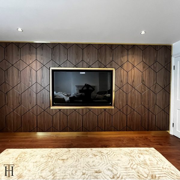 brushed brass TV surround and wall decor