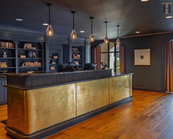 The Publisher Hotel aged brass reception desk