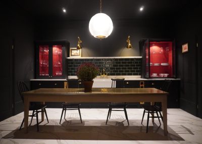 long brass kitchen table in dark aesthetic kitchen