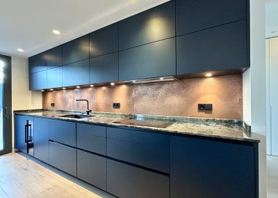 patina copper splashback in charcoal grey kitchen