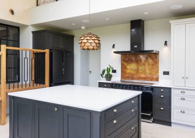 burnished copper splashback in white and grey kitchen